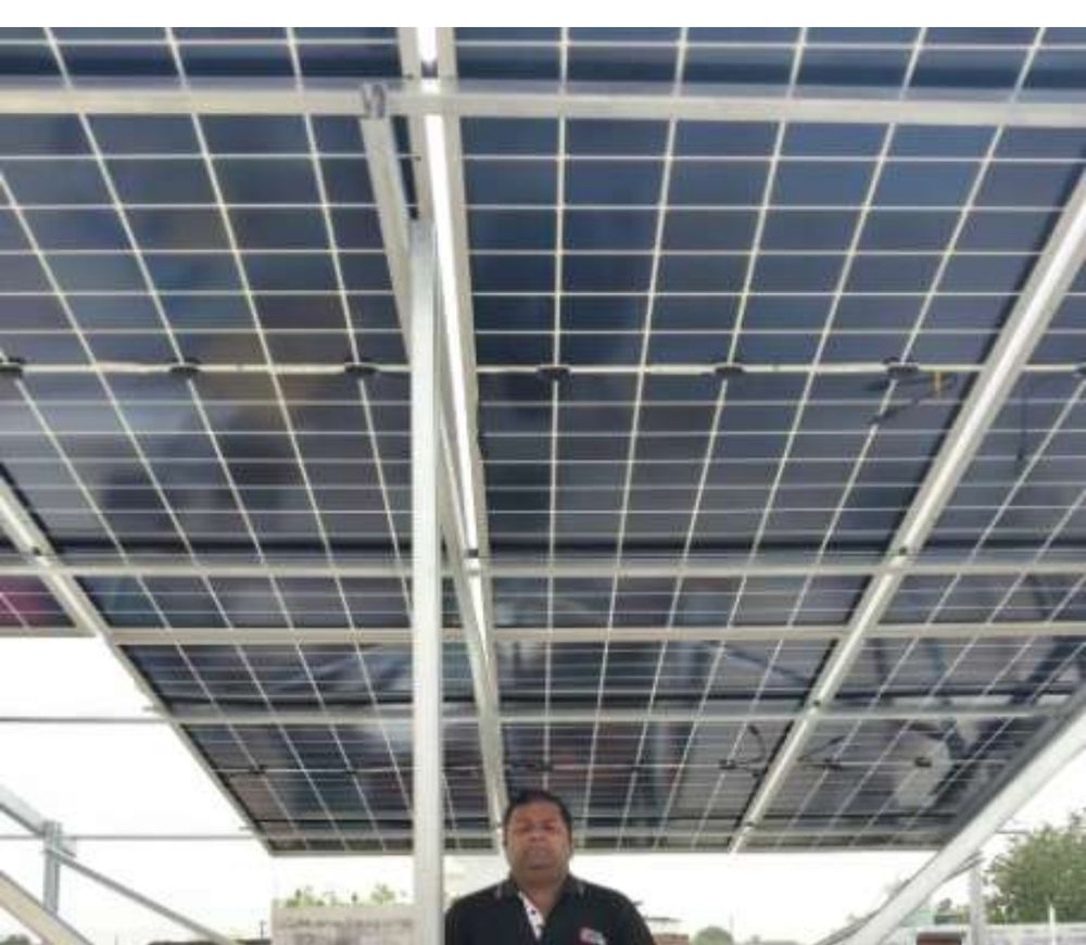 Close-up underside view of installed rooftop solar panels in Indralok Colony, Alambagh, Lucknow